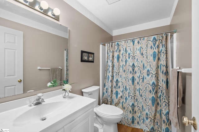 bathroom featuring vanity, toilet, and walk in shower