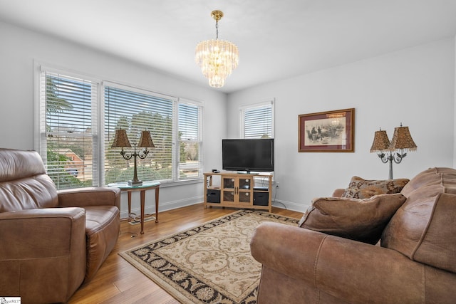 living room featuring an inviting chandelier and hardwood / wood-style floors