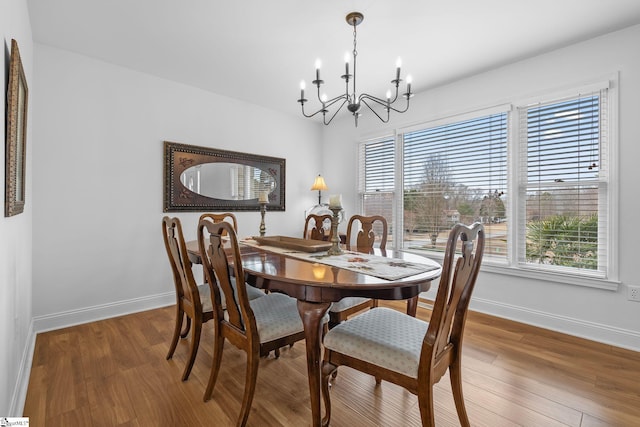 dining room featuring hardwood / wood-style floors and a chandelier