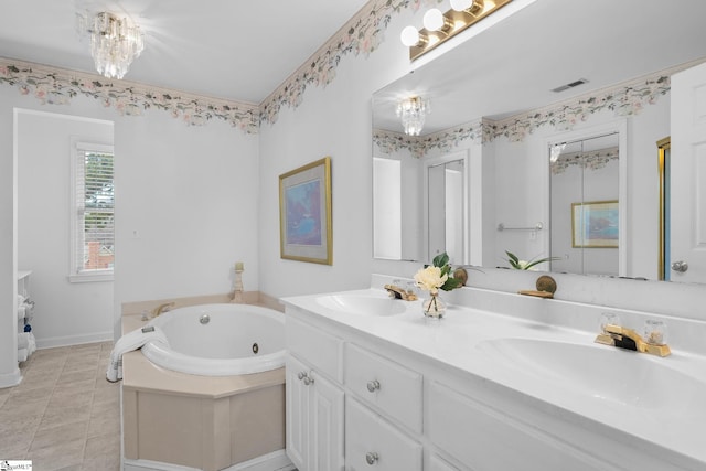 bathroom with vanity, tile patterned flooring, a bathtub, and an inviting chandelier