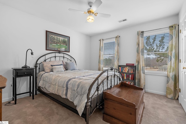 bedroom featuring light colored carpet and ceiling fan