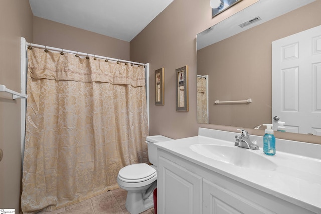 bathroom featuring vanity, toilet, and tile patterned flooring