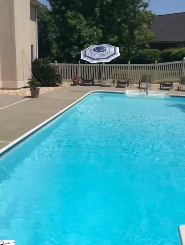 view of swimming pool with a patio area