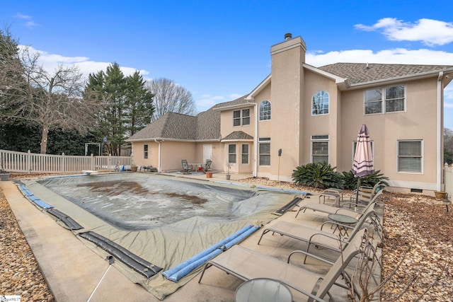 view of swimming pool featuring a patio area and a diving board