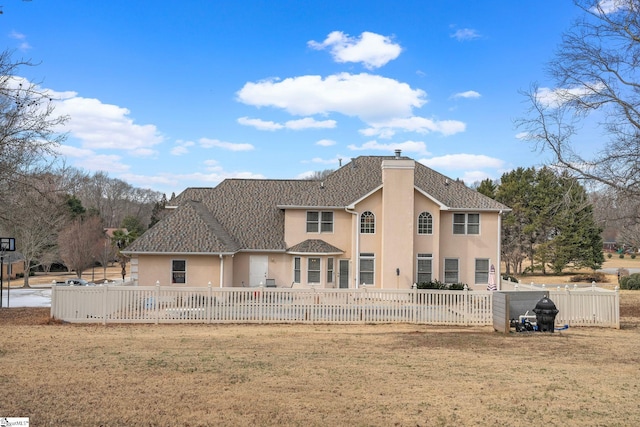 rear view of house with a yard