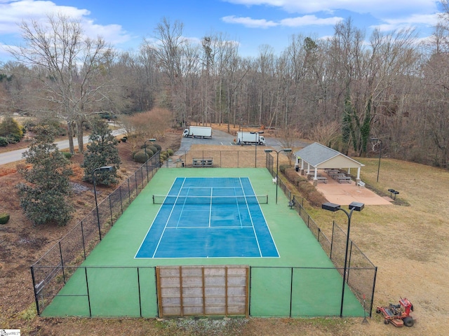 view of tennis court with a yard