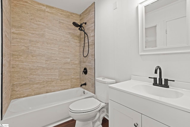 full bathroom with vanity, tiled shower / bath combo, and toilet