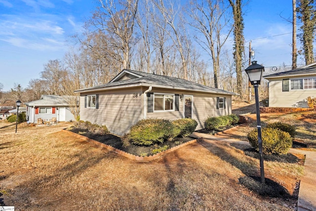 view of side of home featuring a yard