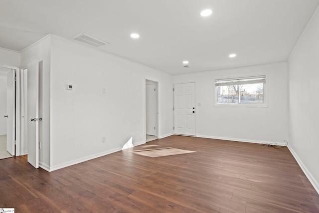 unfurnished room featuring crown molding and dark hardwood / wood-style floors