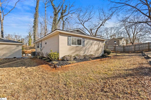 view of side of home with a yard and central air condition unit