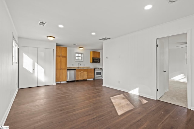 unfurnished living room featuring sink, crown molding, and dark hardwood / wood-style floors