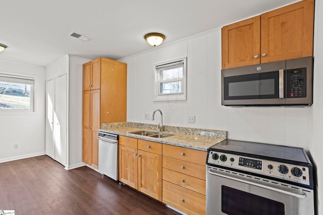 kitchen featuring light stone counters, appliances with stainless steel finishes, sink, and plenty of natural light