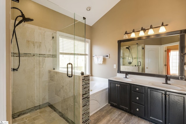 bathroom featuring independent shower and bath, vanity, lofted ceiling, and hardwood / wood-style floors