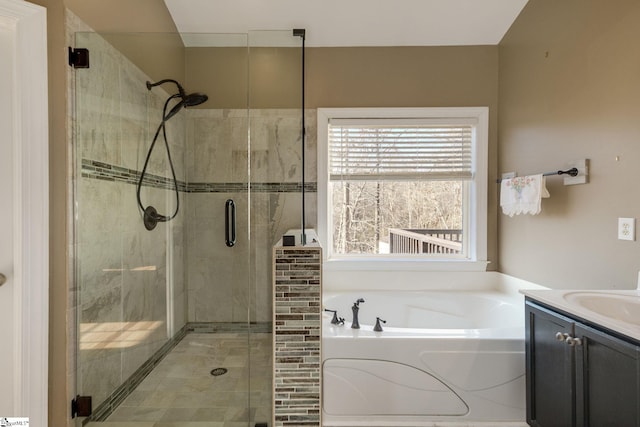 bathroom with vanity and independent shower and bath