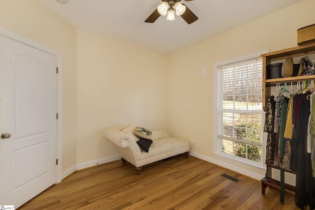 unfurnished room with ceiling fan, wood-type flooring, and a wealth of natural light