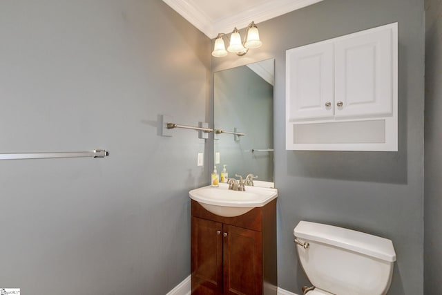 bathroom featuring vanity, ornamental molding, and toilet