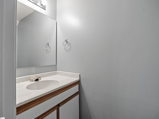 bathroom with vanity and a textured ceiling