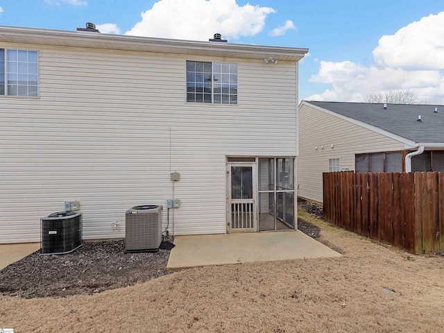 back of house with central AC unit, a patio area, and a sunroom