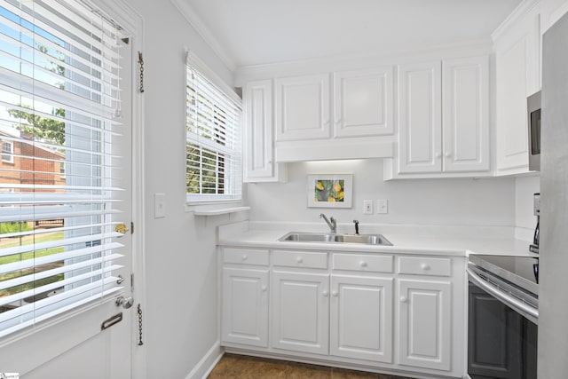 kitchen with white cabinetry, ornamental molding, sink, and electric range