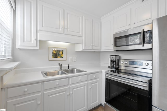 kitchen with white cabinetry, appliances with stainless steel finishes, and sink