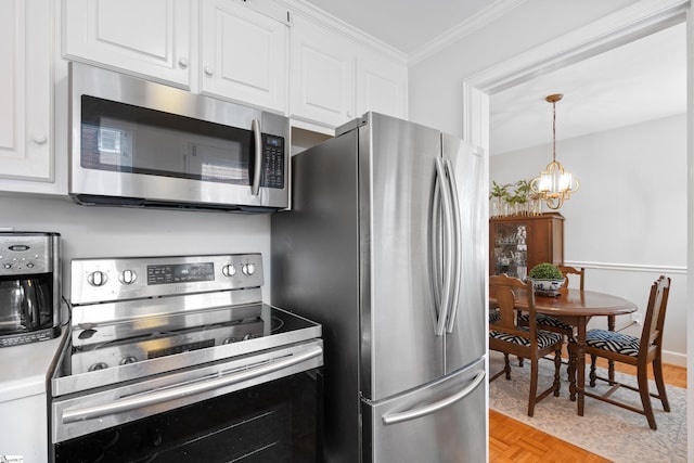 kitchen with white cabinetry, light parquet flooring, stainless steel appliances, and decorative light fixtures