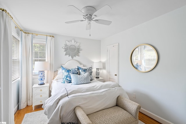 bedroom with ceiling fan and light hardwood / wood-style floors