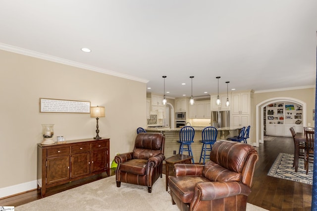 living room featuring crown molding, dark wood-type flooring, and built in shelves