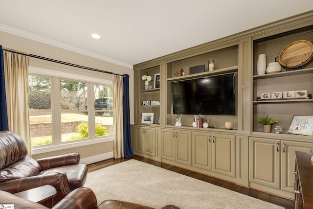 living room featuring crown molding, built in shelves, and dark wood-type flooring