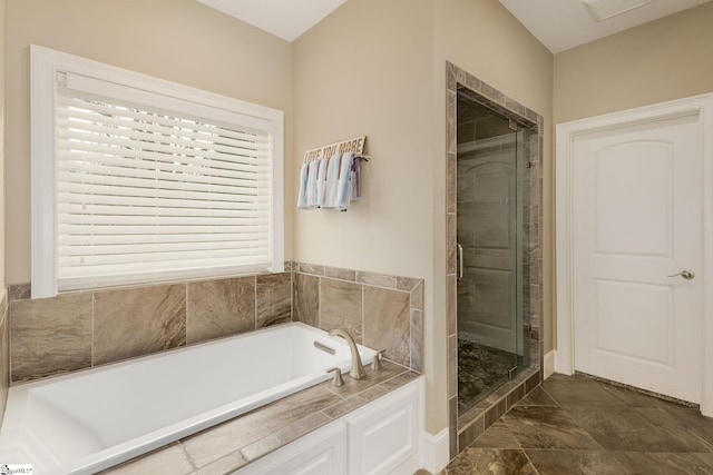 bathroom featuring shower with separate bathtub