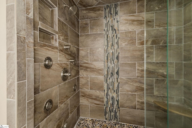 bathroom with tiled shower