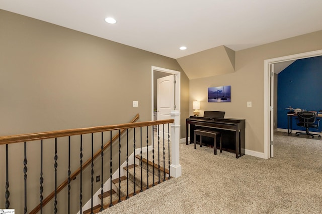 corridor featuring lofted ceiling and light colored carpet