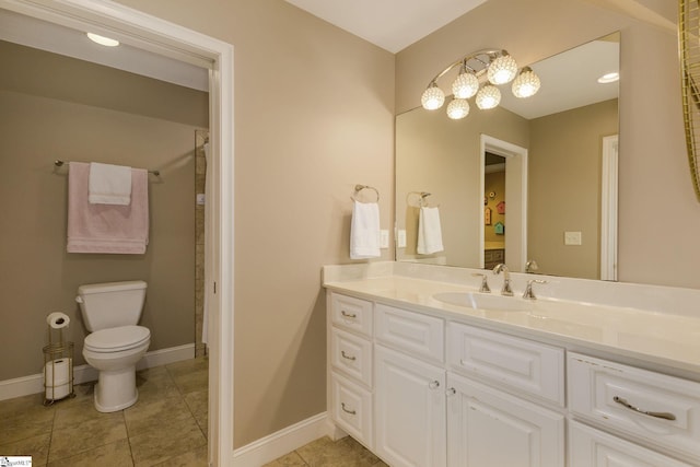 bathroom featuring tile patterned floors, vanity, and toilet