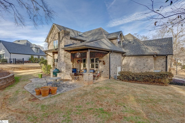 back of property featuring a yard and a patio area