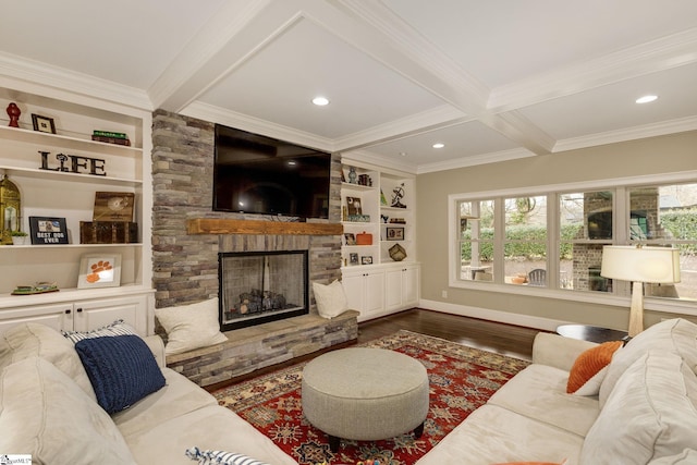 living room featuring a stone fireplace, ornamental molding, dark hardwood / wood-style flooring, built in features, and beam ceiling