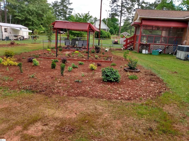 view of yard featuring central AC and a sunroom