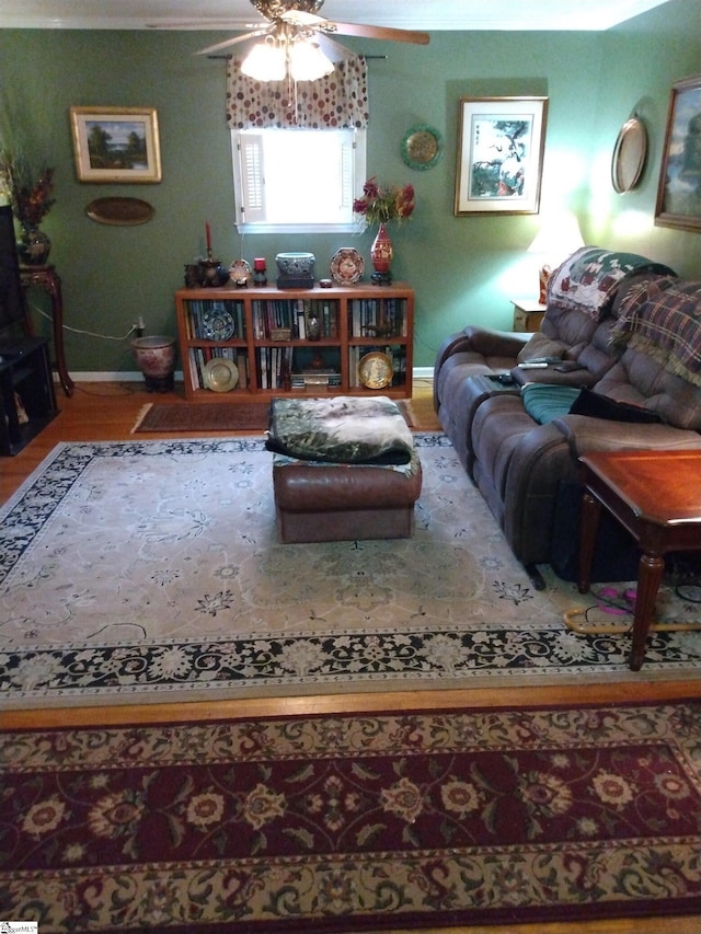 living room featuring hardwood / wood-style floors and ceiling fan