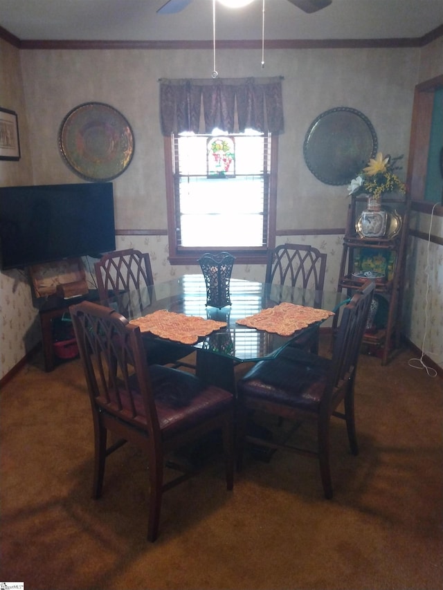 dining room featuring ceiling fan, ornamental molding, and carpet flooring