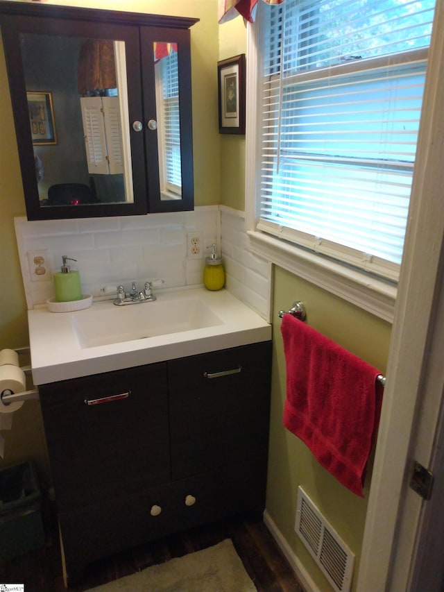 bathroom with vanity and decorative backsplash