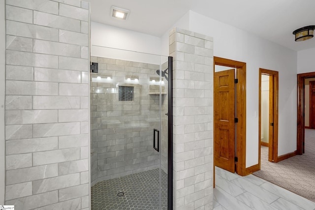 bathroom featuring a shower with shower door