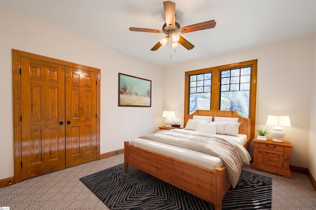 carpeted bedroom featuring ceiling fan and a closet