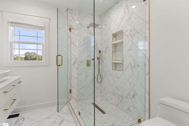 bathroom featuring a shower with door, vanity, and toilet