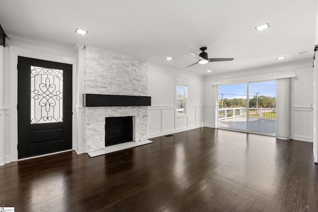 unfurnished living room featuring wood-type flooring, a fireplace, and ceiling fan