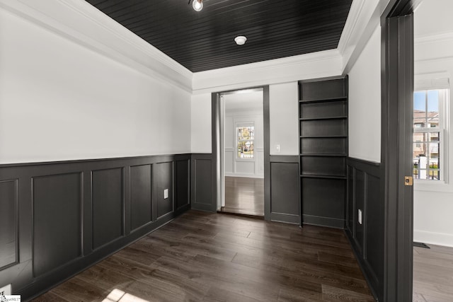 interior space with ornamental molding and dark hardwood / wood-style flooring