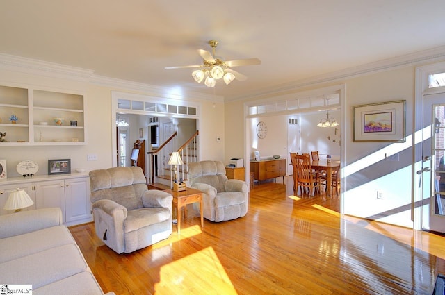 living room with crown molding, ceiling fan, and light hardwood / wood-style flooring