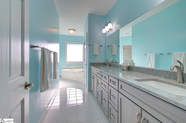 bathroom with tile patterned flooring, vanity, and a bathing tub