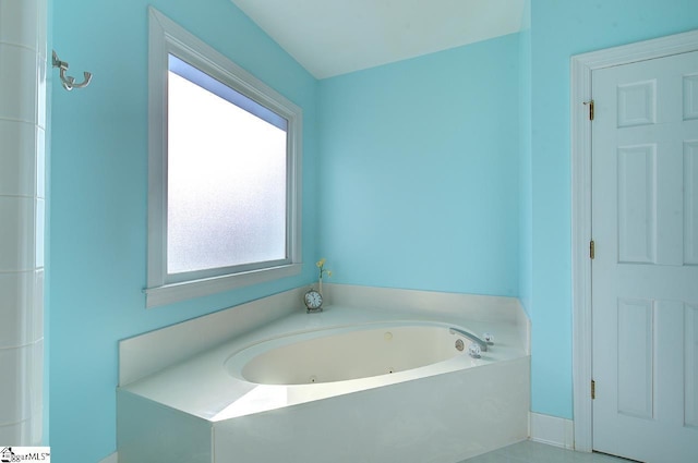 bathroom with a washtub and plenty of natural light