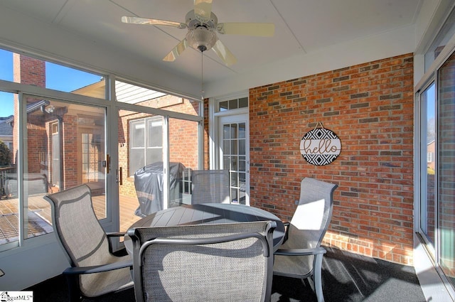 sunroom / solarium featuring ceiling fan