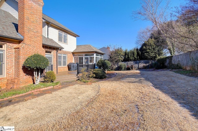 exterior space featuring a sunroom and a deck