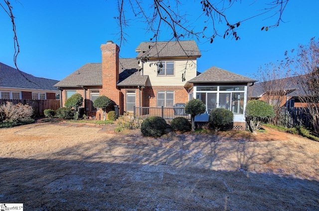 rear view of property with a sunroom