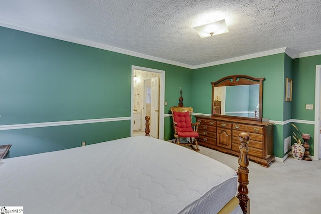 bedroom with ensuite bath, ornamental molding, a textured ceiling, and carpet flooring